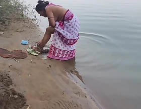 Indian village wife bathing in the river in outdoor area